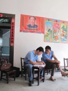 Two men discussing a survey in China