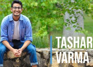 Tashar Varma sitting outside on a stone bench