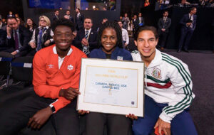 Brianna holding certificate with two men on either side.