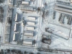 Aerial view of buildings and vehicles covered in snow
