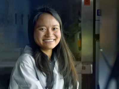 Portrait of Aye in a lab wearing a white lab coat