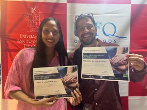 Two people smiling with certificates