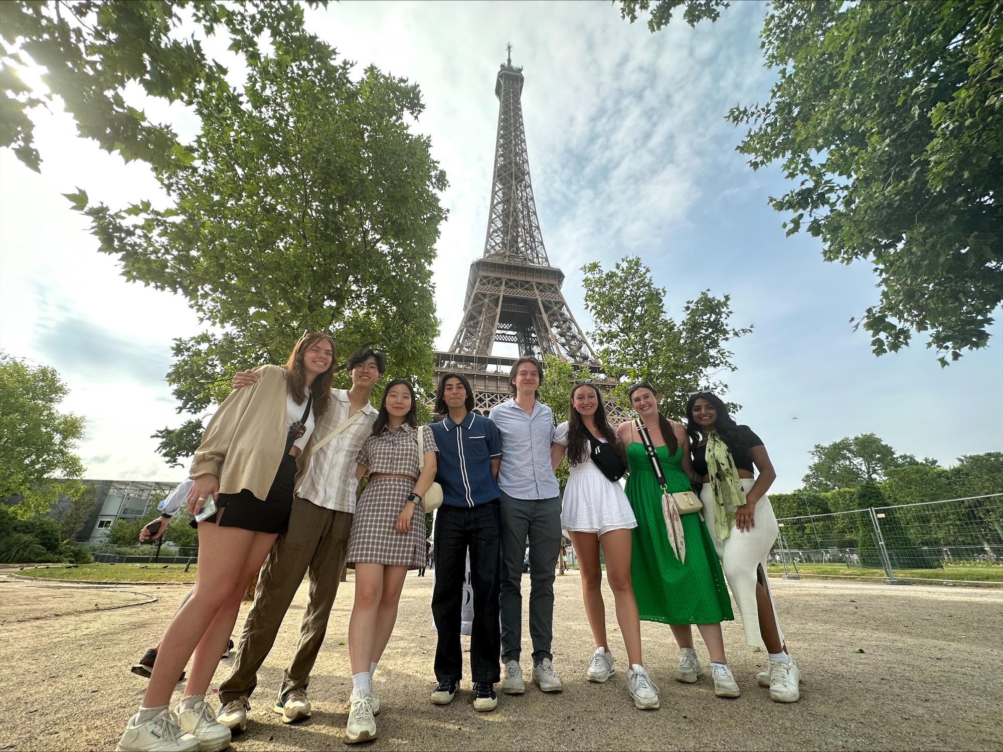 students pose in front of the Eiffel Tower