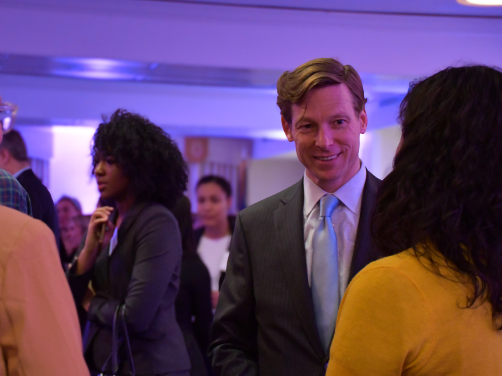Interim Chancellor Lee Roberts visits with students at the UNC Global Affairs Washington Week reception with alumni.